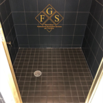 Black tiled shower after cleaning, cleaning, re-grout and new silicone